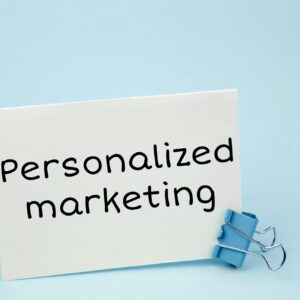 Personalized marketing. Note written on a white sticker with paper clip.